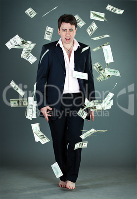 man in a suit throws money