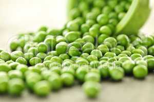 Spilled bowl of green peas