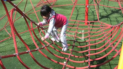 Girl Climbing Web At Playground