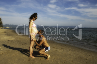 Pregnant Woman relaxing at the Beach with her Husband, Italy