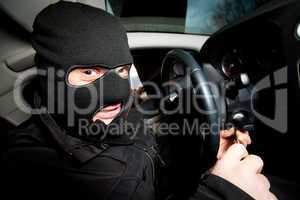 robber and the thief in a mask hijacks the car