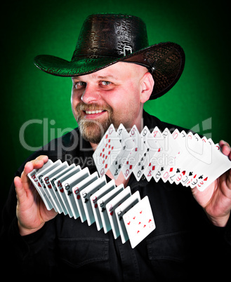 man skilfully shuffles playing cards