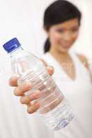 Asian Chinese Girl Holding Bottle of Pure Water to Camera