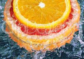 orange and grapefruit in streaming water