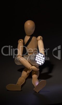 wood mannequin and flashlight