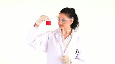 Laborarbeiterin im Kittel hält ein Reagenzglas