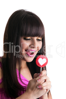 young brunette woman look at heart lollipop