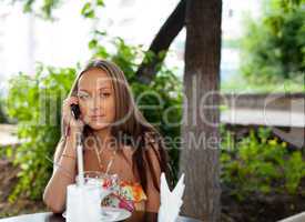 Beauty woman in summer cafe talk a phone