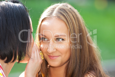 Two beauty woman talk a secret