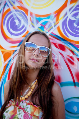woman in glass stand near urban graffiti wall