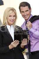 Businessman and Businesswoman Using Tablet Computer