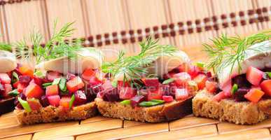 Sandwiches with rye bread, herring and vegetables