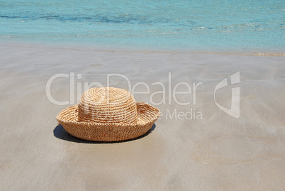 Hat on sand by sea