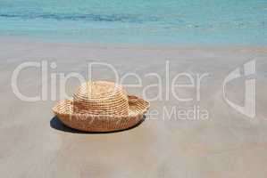 Hat on sand by sea