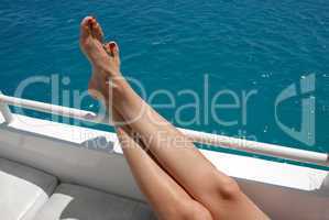 Woman legs on yacht