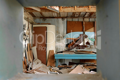ramshackled room with boarded up window