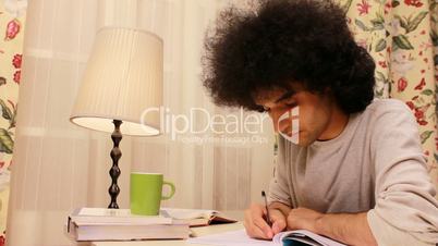 young man studying and writing on the book 2