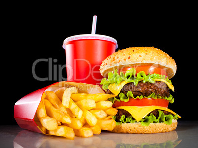 Tasty hamburger and french fries on a dark