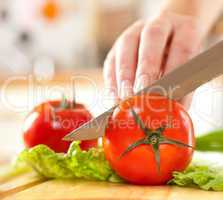 Woman's hands cutting vegetables