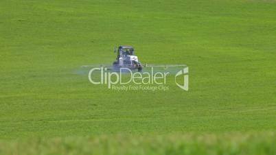 Farm tractor spraying field