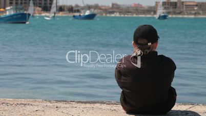 child sitting at the seashore