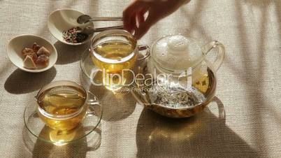 Woman mixes brown sugar in cup of tea