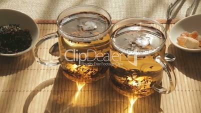 Woman adds brown sugar in glass of tea