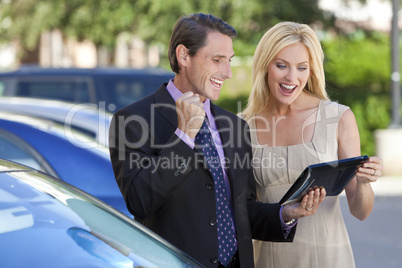 Successful Businessman and Businesswoman Using Tablet Computer