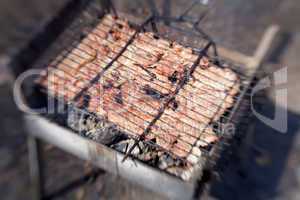 Grilled pork steaks in the grid roasting in barbecue