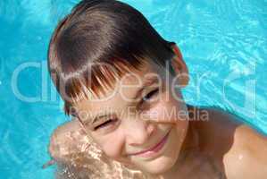 Teen boy in swimming pool portrait