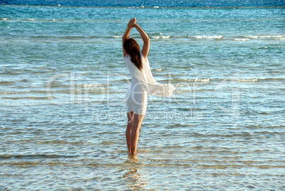 Woman in white dress in sea