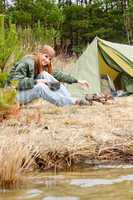 Camping woman tent cook food fire nature