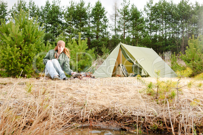 Camping woman tent cook food fire nature