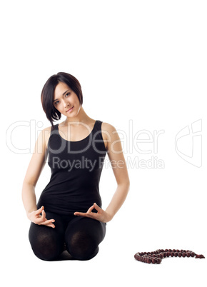 Young woman relax in yoga asana with beads
