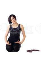 Young woman relax in yoga asana with beads