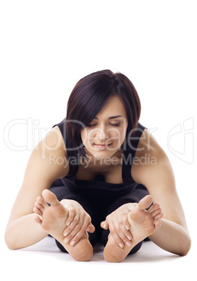 woman relaxed in yoga pose - paschimottanasana