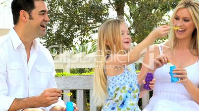 Multi-Ethnic Family Fun Blowing Soap Bubbles