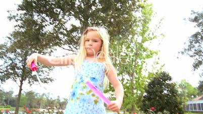 Little Girl Playing with Bubble Wand