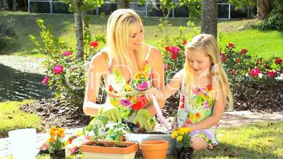 Blonde Mom & Daughter Gardening