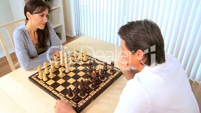 Couple Playing Chess at Home