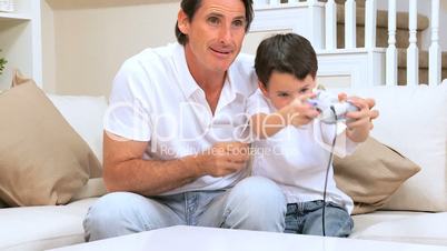 Father with Little Boy Winning Electronic Game