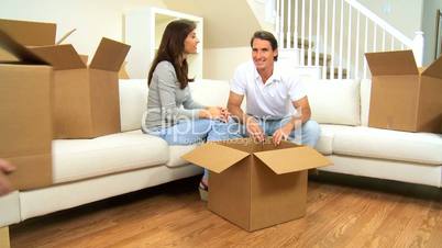 Family with Moving Home Cartons to be Unpacked