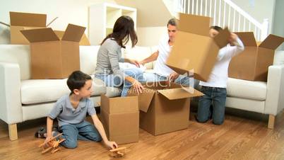 Family With Empty Boxes From Moving Home