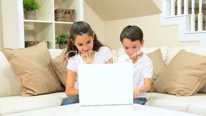 Caucasian Children Using Laptop at Home