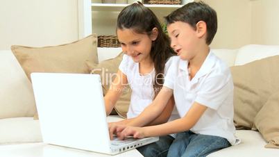 Children Playing Games on Laptop
