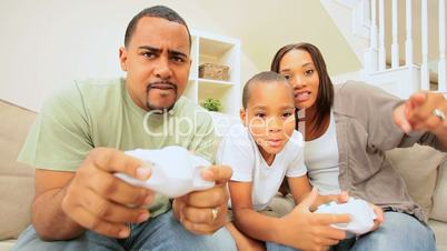 Young Family Competing on a Games Console