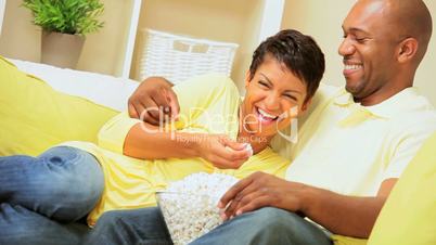 Young Ethnic Couple Relaxing with Popcorn