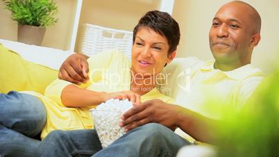 African-American Couple at Home Eating Popcorn