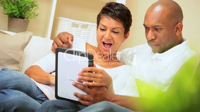 Young Ethnic Couple Using Wireless Tablet for Webchat