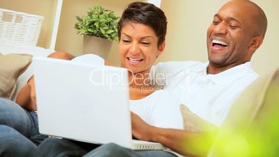 Ethnic Couple Using Laptop for Webchat